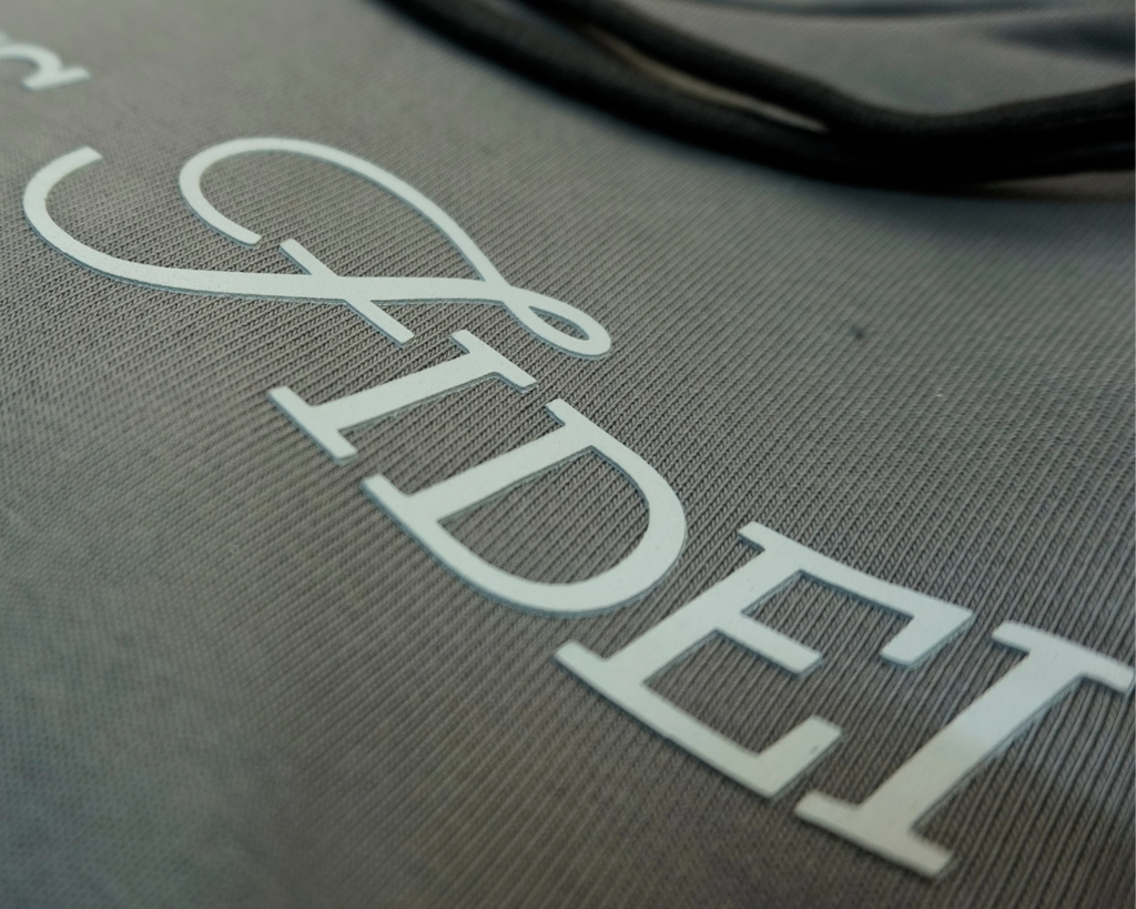 Charcoal grey Saltus Fidei hoodie, close-up product detail