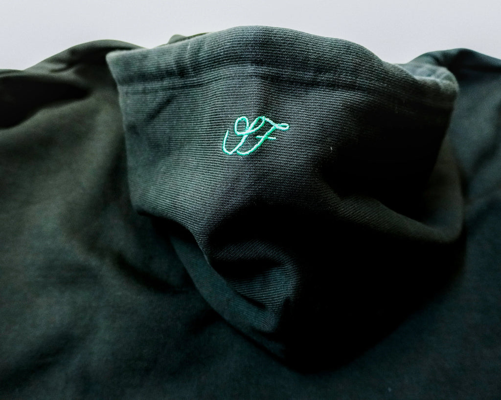 Black Saltus Fidei hoodie, close-up of ribbed cuff and hem detail