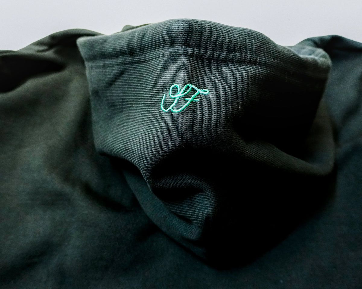 Black Saltus Fidei hoodie, close-up of ribbed cuff and hem detail