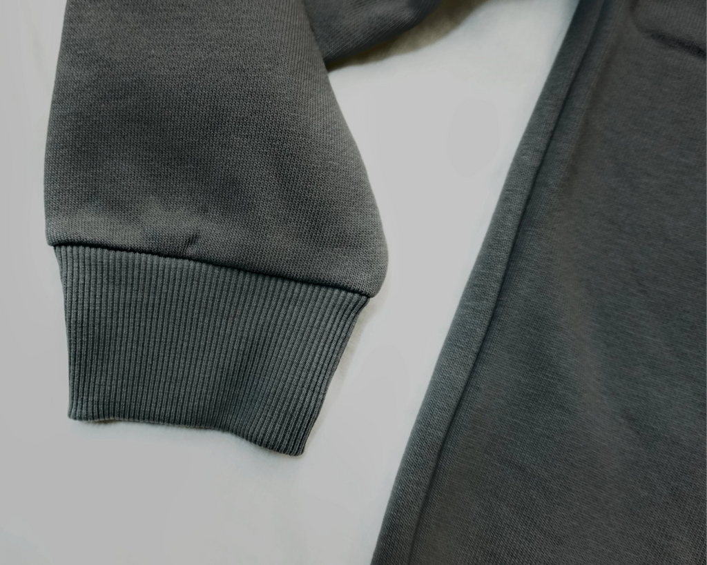 Charcoal grey Saltus Fidei hoodie, close-up product detail
