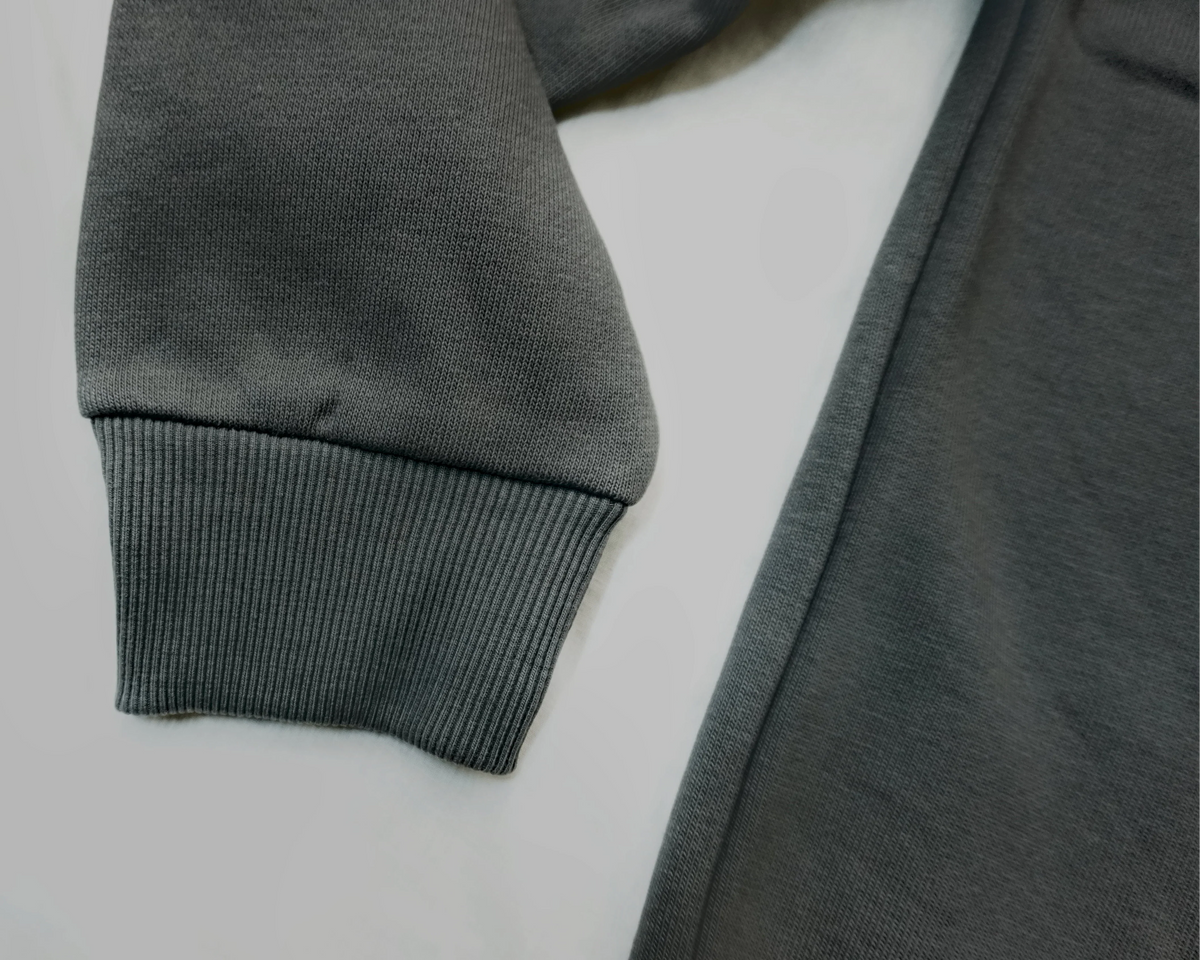 Charcoal grey Saltus Fidei hoodie, close-up product detail