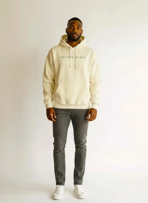 Model wearing the off-white Saltus Fidei hoodie, studio shot