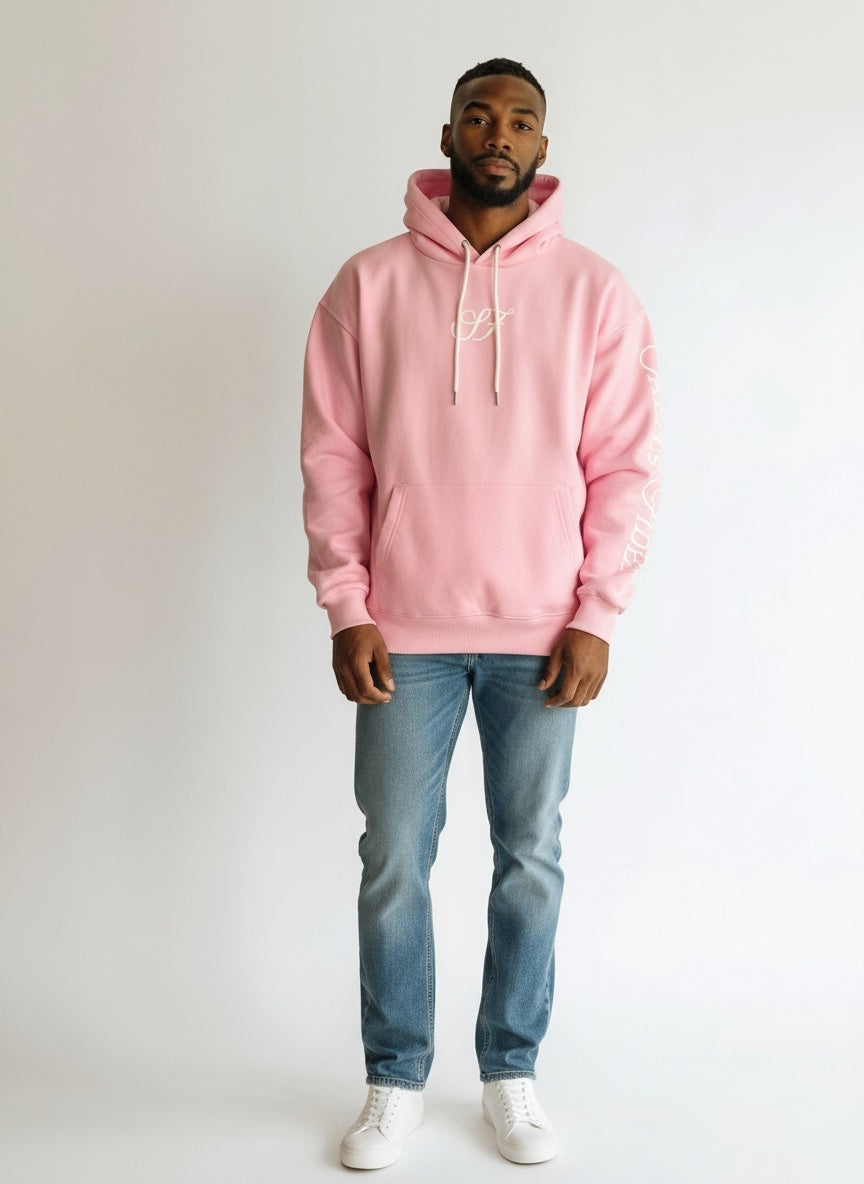 Model wearing the baby pink Saltus Fidei hoodie, studio shot