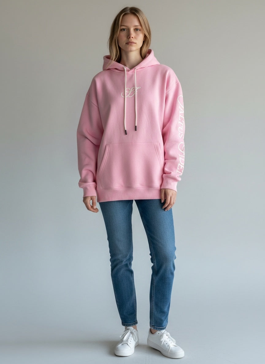 Model wearing the baby pink Saltus Fidei hoodie, alternate studio angle