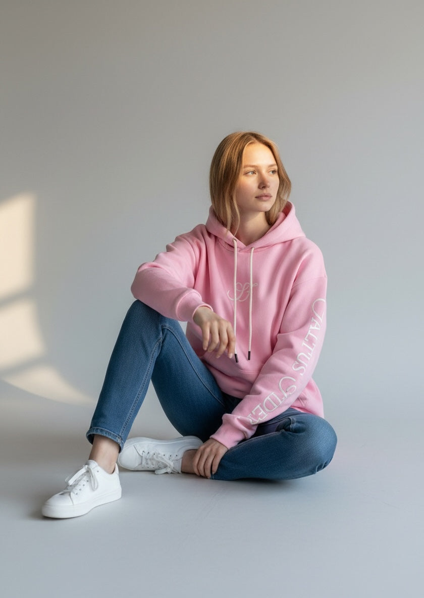 Model wearing the baby pink Saltus Fidei hoodie, alternate studio angle