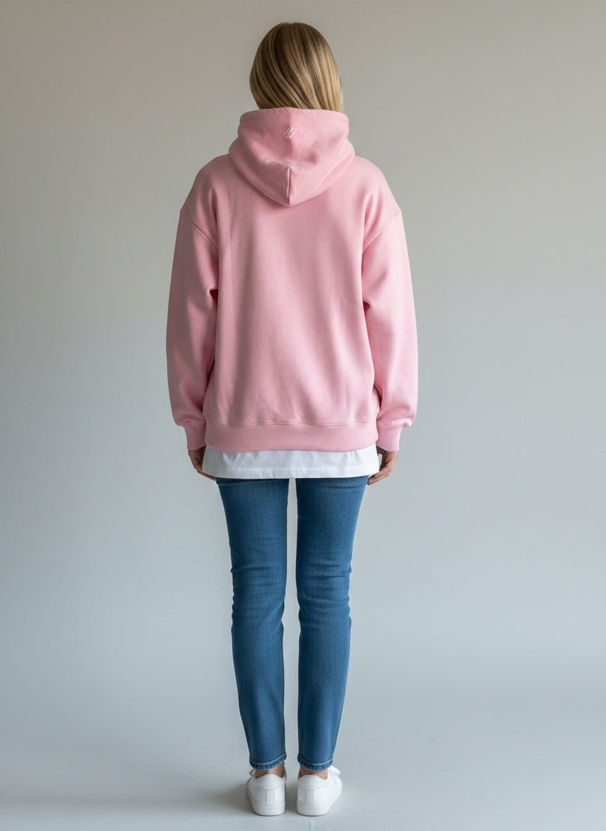Model wearing the baby pink Saltus Fidei hoodie, alternate studio angle