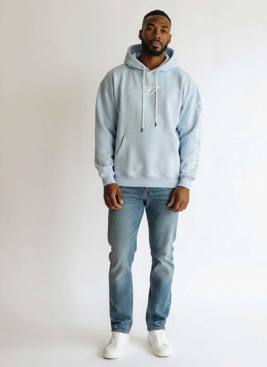 Model wearing the sky blue Saltus Fidei hoodie, alternate studio angle