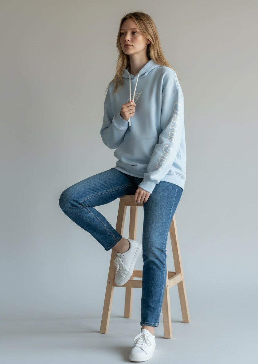 Model wearing the sky blue Saltus Fidei hoodie, alternate studio angle